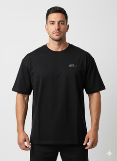 A man stands facing forward against a plain background, wearing the Men's Gym Clothes AU BDHQ Oversized T-Shirt (180GSM) – Lightweight Drop-Shoulder Cut in black with a subtle 90 KG chest graphic.
